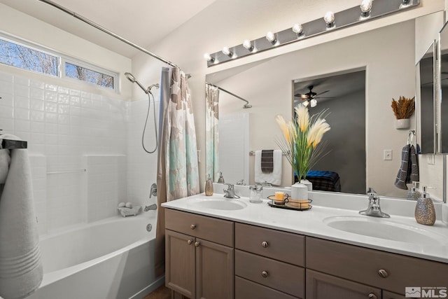 full bathroom with double vanity, shower / bathtub combination with curtain, ceiling fan, and a sink