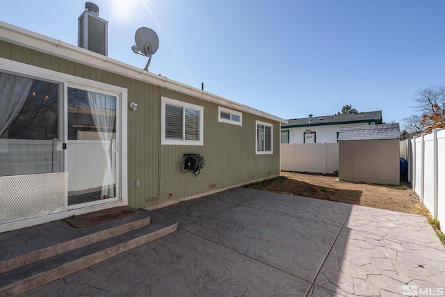 rear view of property featuring a patio area, a fenced backyard, a storage shed, and an outdoor structure