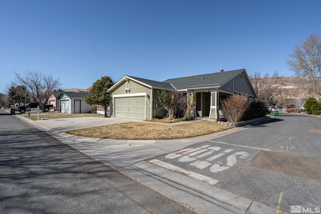 single story home featuring concrete driveway and an attached garage