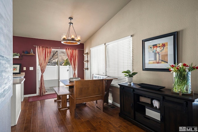 dining space featuring a chandelier, baseboards, lofted ceiling, and dark wood-style floors