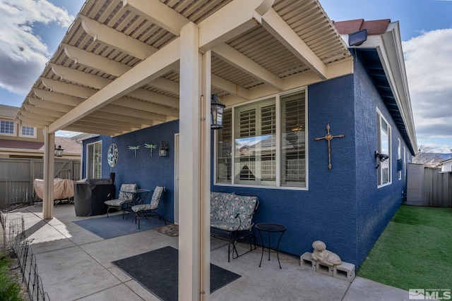 view of patio / terrace featuring fence