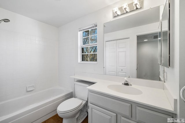 full bath featuring toilet, shower / bathing tub combination, and vanity