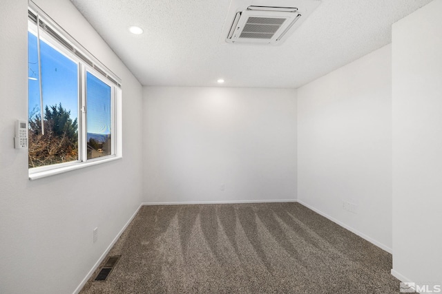 empty room with carpet floors, recessed lighting, visible vents, and baseboards