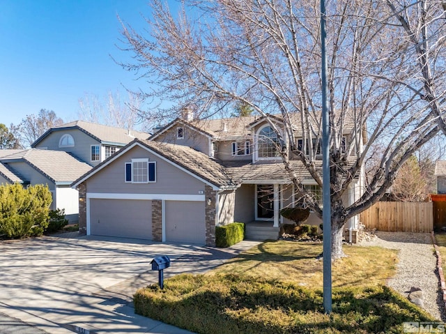 traditional-style house featuring a garage, covered porch, fence, driveway, and a front yard