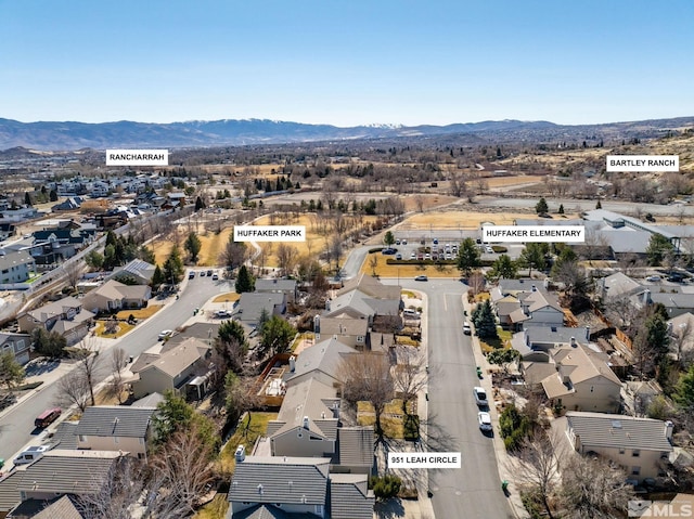 drone / aerial view featuring a residential view and a mountain view