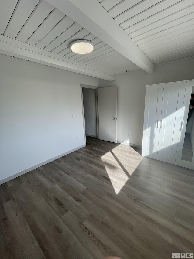 unfurnished room with wood ceiling, baseboards, beam ceiling, and wood finished floors