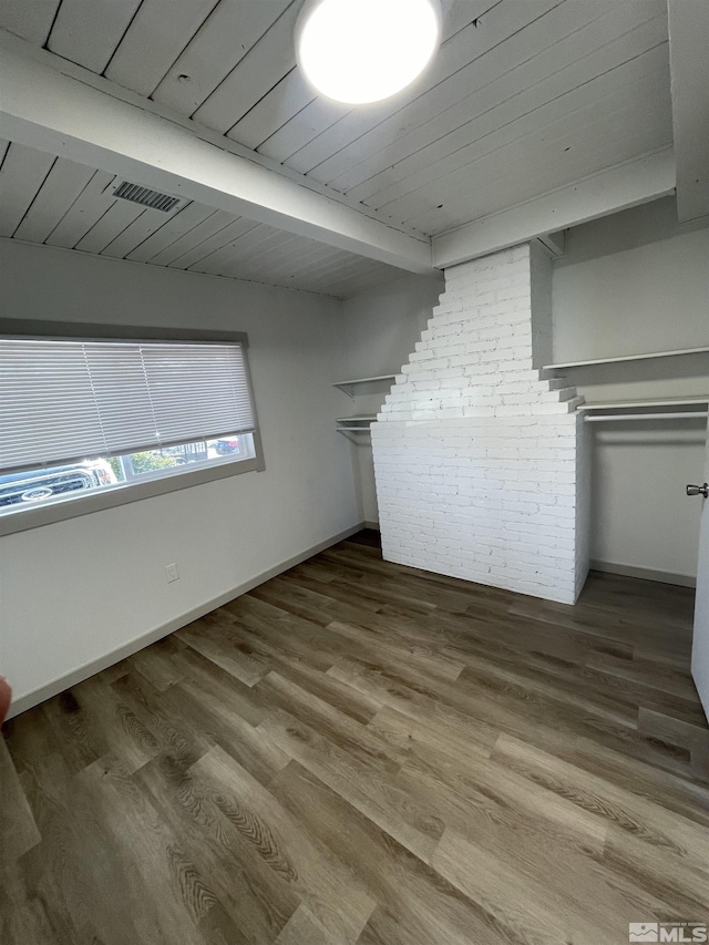 interior space with wood ceiling, visible vents, beamed ceiling, and wood finished floors