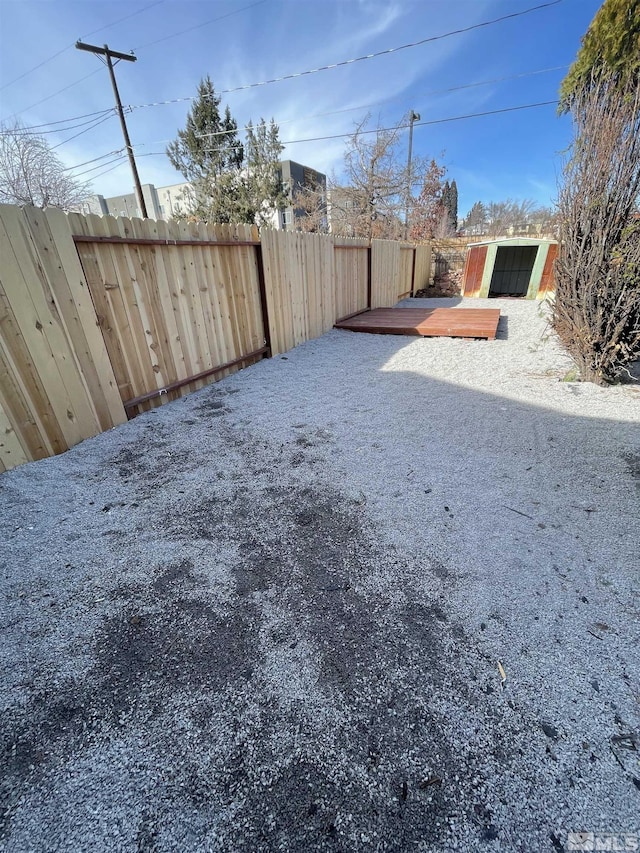 view of yard featuring a fenced backyard and a wooden deck