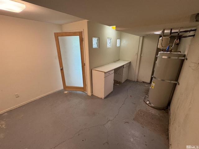 finished basement featuring strapped water heater and baseboards