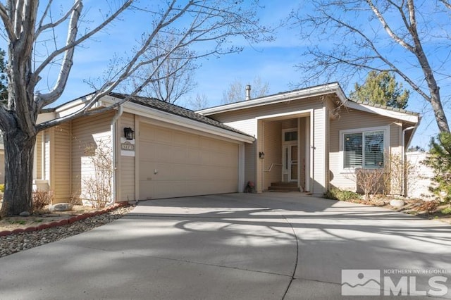 view of front of property with concrete driveway and an attached garage