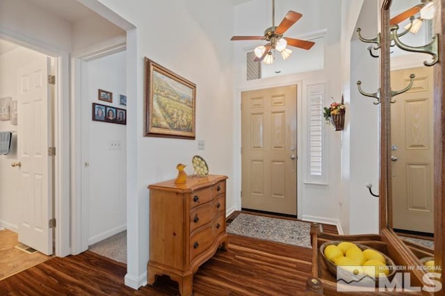 entryway with a ceiling fan, baseboards, and wood finished floors