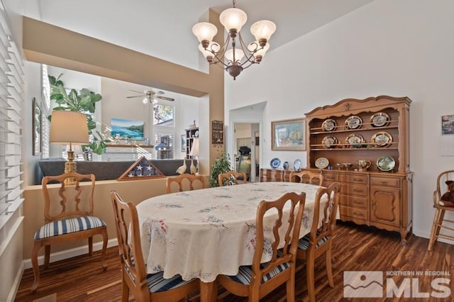 dining area featuring baseboards, dark wood finished floors, and ceiling fan with notable chandelier