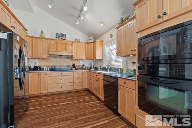 kitchen featuring light brown cabinets, a sink, vaulted ceiling, black appliances, and dark wood finished floors