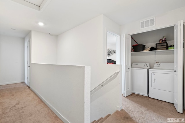 laundry room featuring light carpet, laundry area, separate washer and dryer, and visible vents