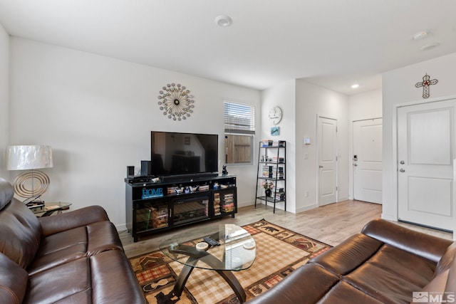 living area featuring light wood-style floors and baseboards