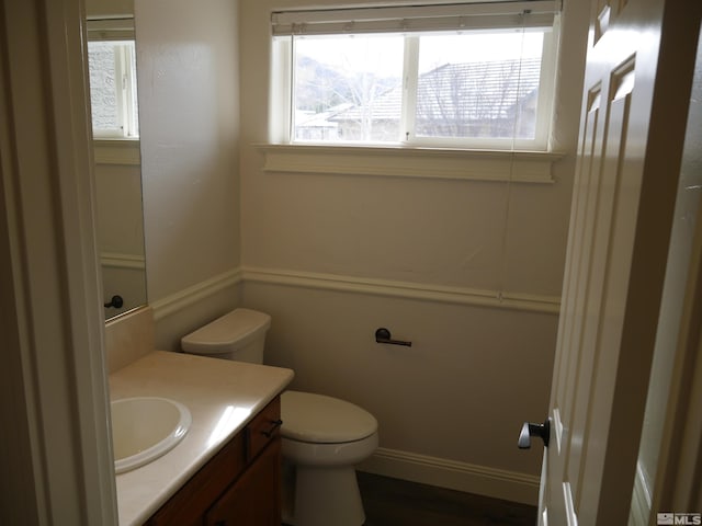 bathroom featuring vanity, toilet, and baseboards