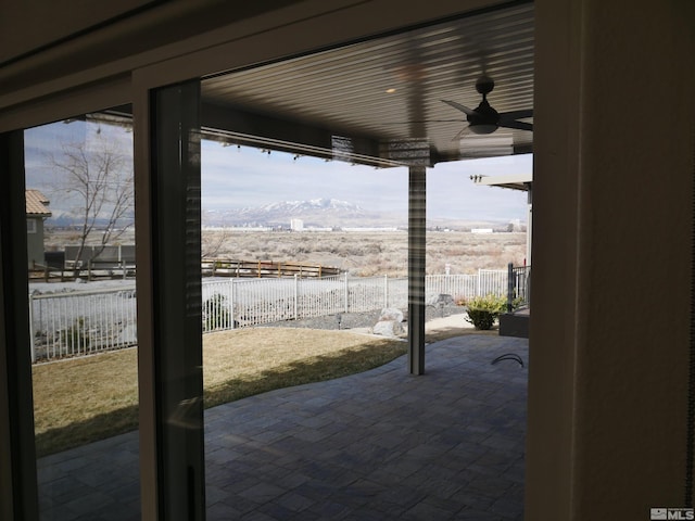 view of patio / terrace with a fenced backyard, a mountain view, and a ceiling fan