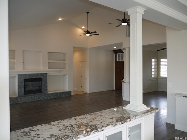 kitchen with ornate columns, built in features, open floor plan, and dark wood finished floors