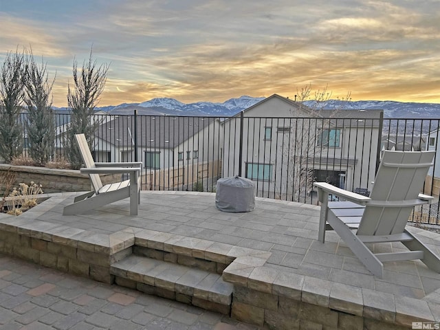 view of patio / terrace featuring a mountain view and fence