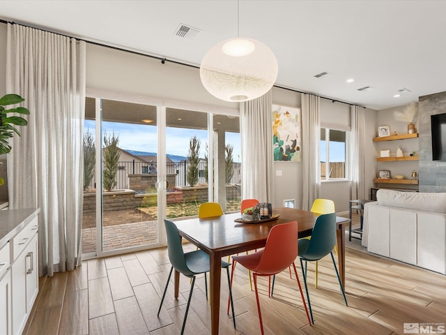 dining area featuring recessed lighting, visible vents, and wood finish floors