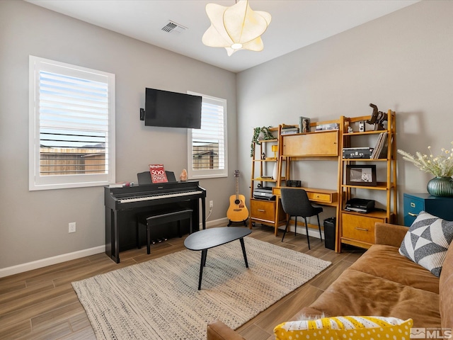 interior space featuring visible vents, baseboards, and wood finished floors