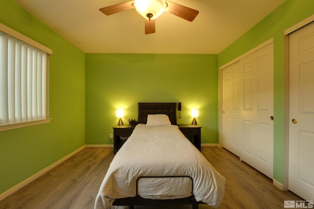 bedroom featuring ceiling fan, wood finished floors, and baseboards