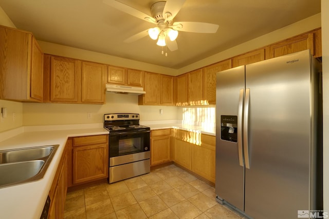 kitchen featuring ceiling fan, under cabinet range hood, a sink, light countertops, and appliances with stainless steel finishes