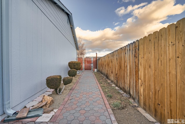 view of side of home featuring a gate and fence