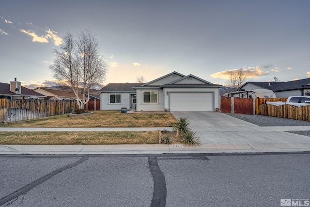 ranch-style home featuring an attached garage, concrete driveway, a front yard, and fence