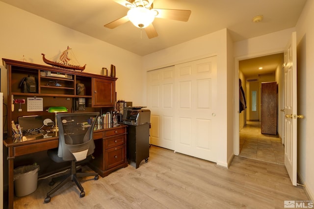 office with light wood-type flooring and a ceiling fan