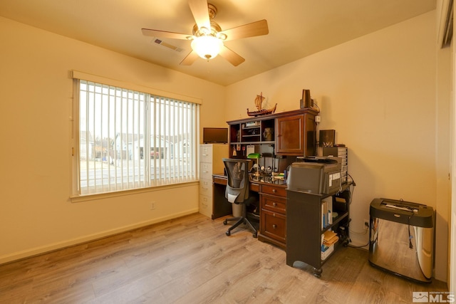 office area featuring light wood-style flooring, visible vents, baseboards, and ceiling fan