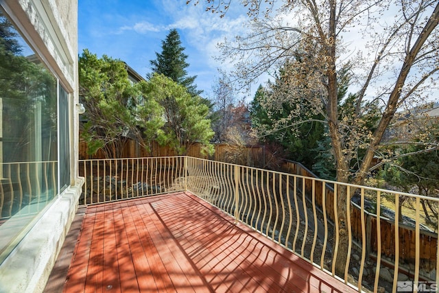 wooden terrace featuring fence