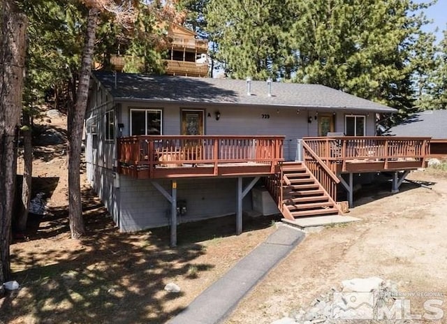 back of property featuring stairway and a deck