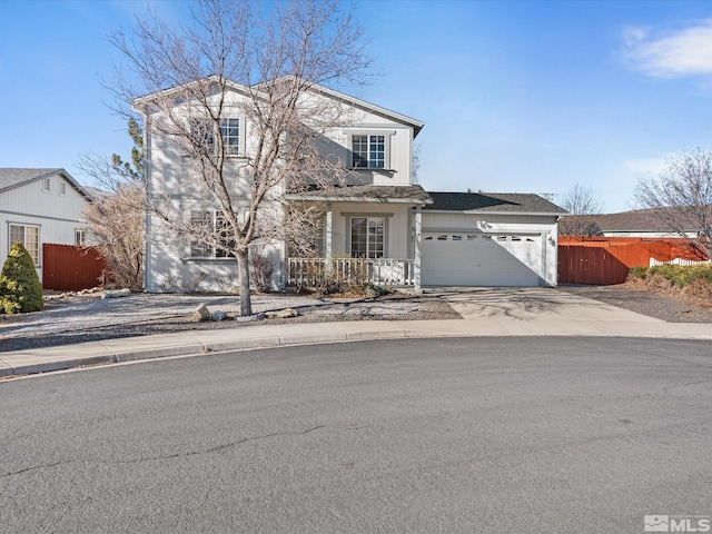 traditional home with a garage, fence, and driveway