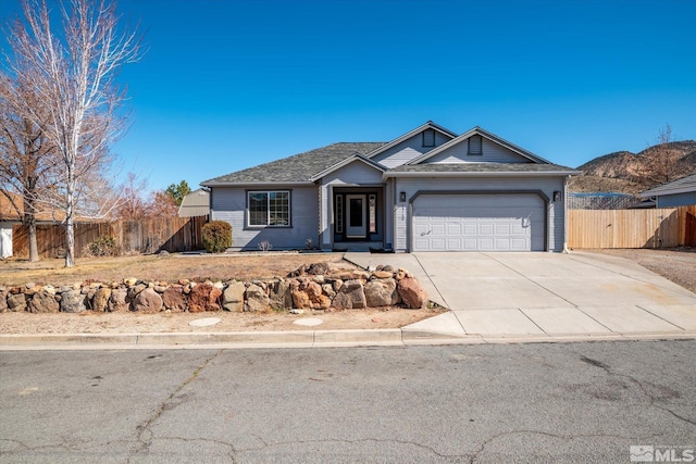 single story home featuring concrete driveway, an attached garage, and fence