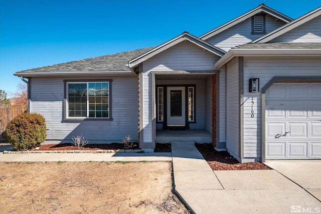 view of front of home featuring a porch, roof with shingles, and an attached garage