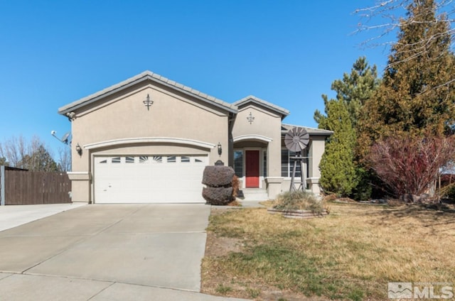 mediterranean / spanish-style house featuring concrete driveway, an attached garage, fence, a front lawn, and stucco siding