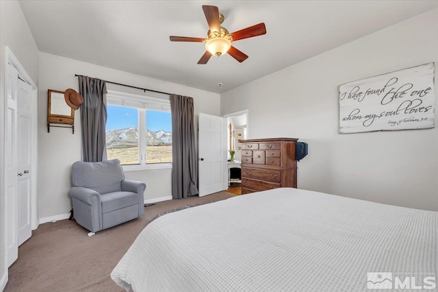 bedroom with carpet flooring, a ceiling fan, and baseboards