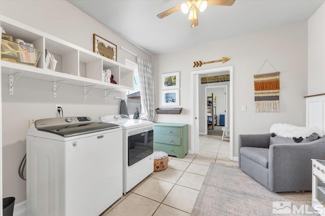 laundry room with laundry area, baseboards, a ceiling fan, washer and dryer, and light tile patterned flooring