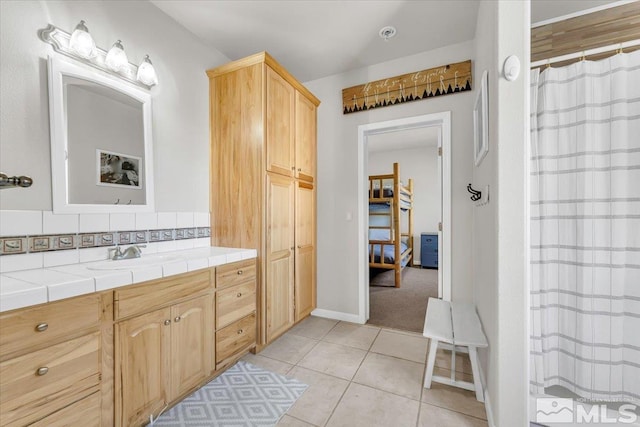 full bathroom with curtained shower, vanity, and tile patterned floors