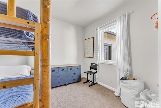 bedroom featuring baseboards and light colored carpet