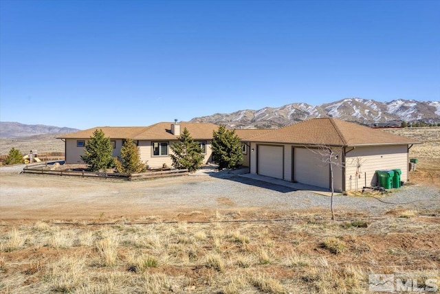 ranch-style home featuring driveway and a mountain view