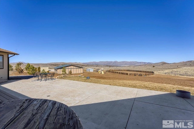 view of patio featuring outdoor dining space and a mountain view