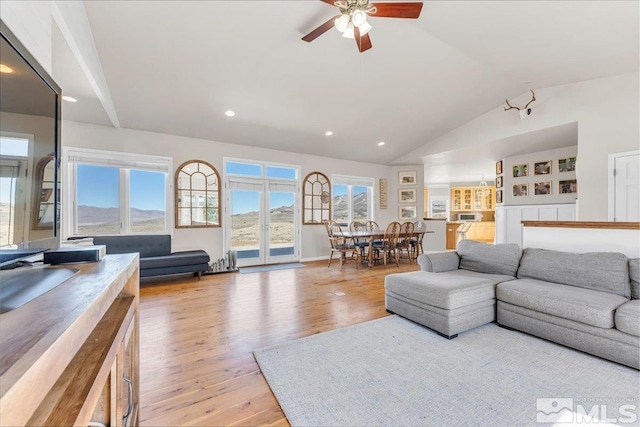 living room featuring light wood finished floors, vaulted ceiling, a ceiling fan, and recessed lighting