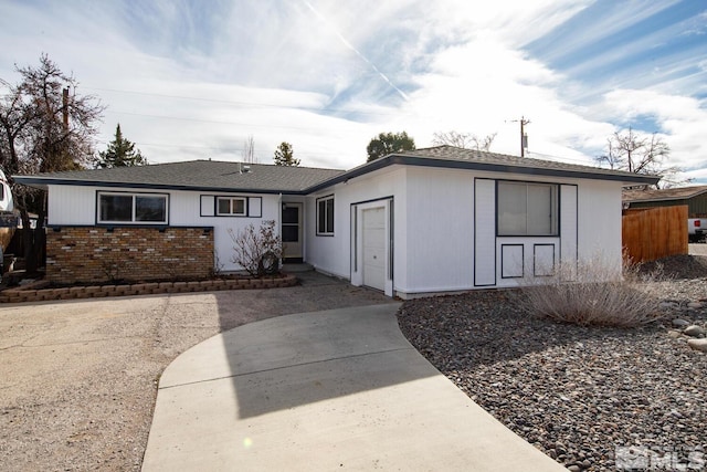 ranch-style house with brick siding and fence