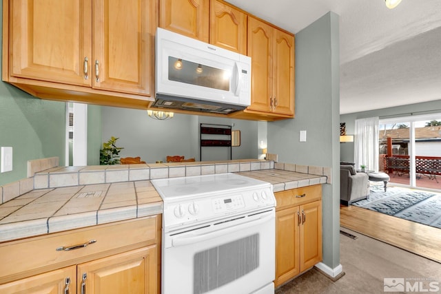 kitchen with white appliances and tile countertops