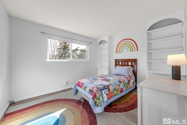 carpeted bedroom with baseboards