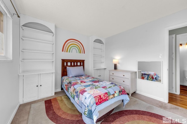 bedroom with carpet and baseboards