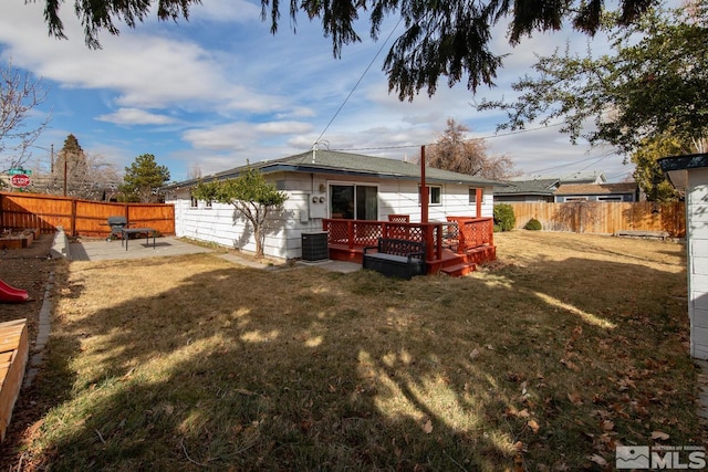 rear view of property featuring a patio area, a fenced backyard, central AC unit, and a lawn