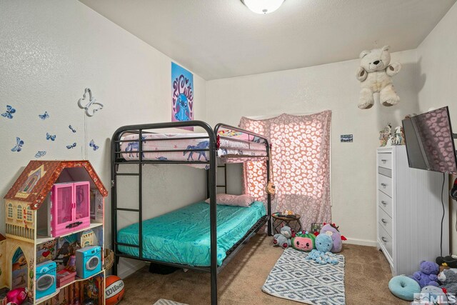 carpeted bedroom featuring baseboards